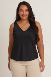 Model Ashleigh wearing size 16 of the Loulou Satin Camisole in colour Black (Black), from the front, cropped image