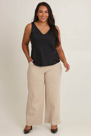 Model Ashleigh wearing size 16 of the Loulou Satin Camisole in colour Black (Black), from the front, showing the whole outfit