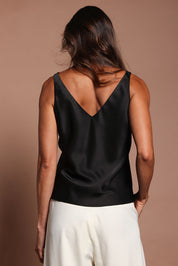Model Madeline wearing size 10 of the Loulou Satin Camisole in colour Black (Black), from the back
