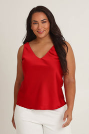 Model Ashleigh wearing size 16 of the Loulou Satin Camisole in colour Red (Red), from the front, cropped image