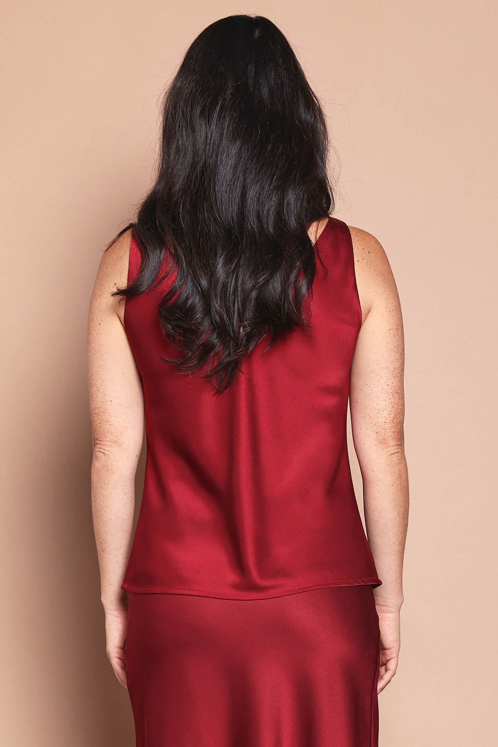 Model Katie wearing size 10 of the Loulou Satin Camisole in colour Shiraz (Red), from the back