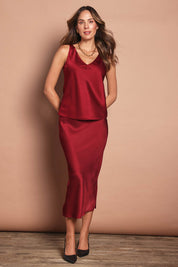 Model Madeline wearing size 10 of the Loulou Satin Camisole in colour Shiraz (Red), from the front, showing the whole outfit