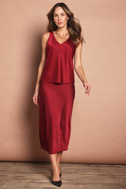 Model Madeline wearing size 10 of the Loulou Satin Camisole in colour Shiraz (Red), from the front, showing the whole outfit