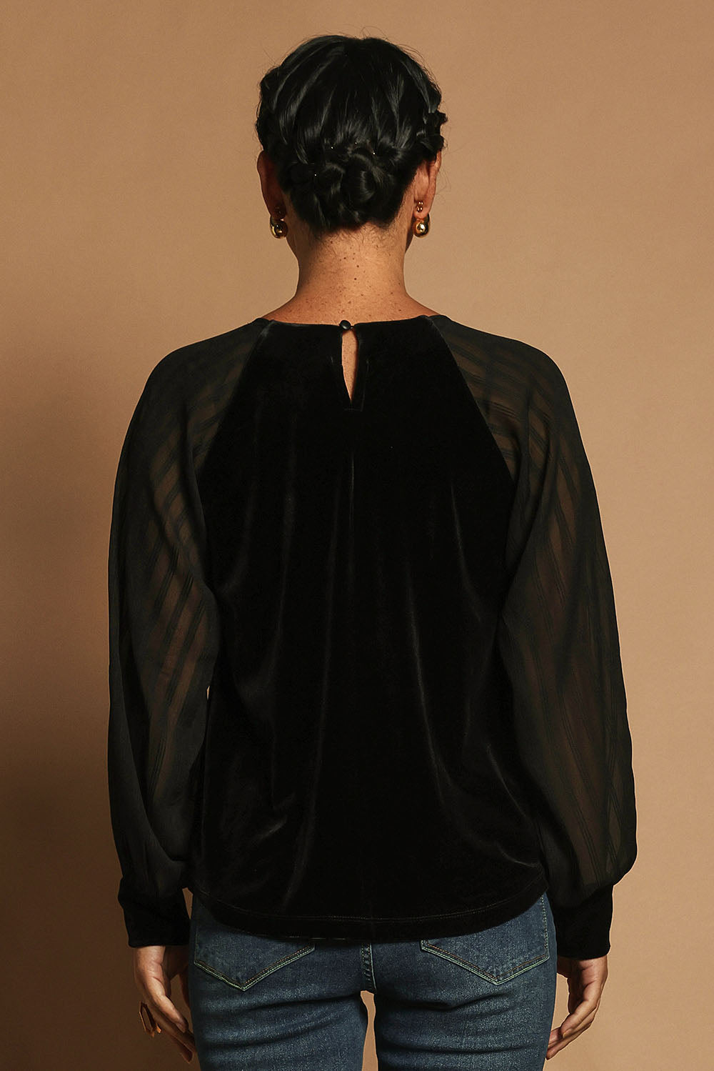 Model Katie wearing size 10 of the Leyla Velvet Blouse in colour Black (Black), from the back
