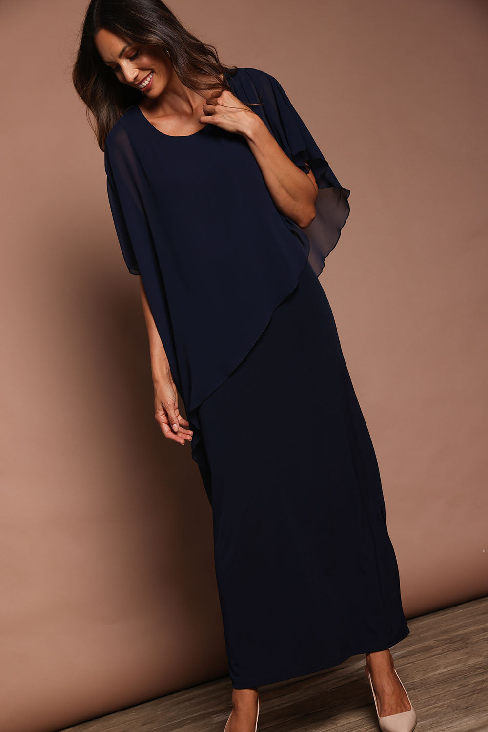 Model Amanda wearing size 10 of The Long Beatrice Dress in colour Navy (Blue), from the front, showing the whole outfit