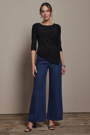 Model Madeline wearing size 10 of the Aisling Top in colour Black (Black), from the front, showing the whole outfit