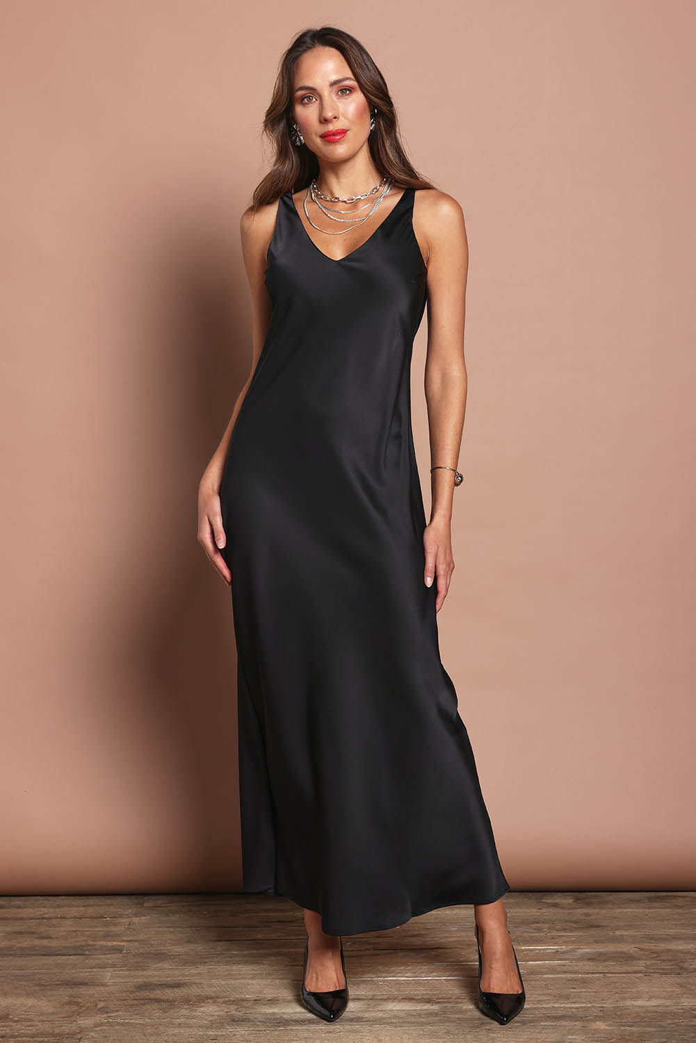 Model Madeline wearing size 10 of the Loulou Satin Slip Dress in colour Black (Black), from the front, showing the whole outfit
