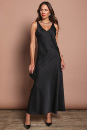 Model Madeline wearing size 10 of the Loulou Satin Slip Dress in colour Black (Black), from the front, showing the whole outfit