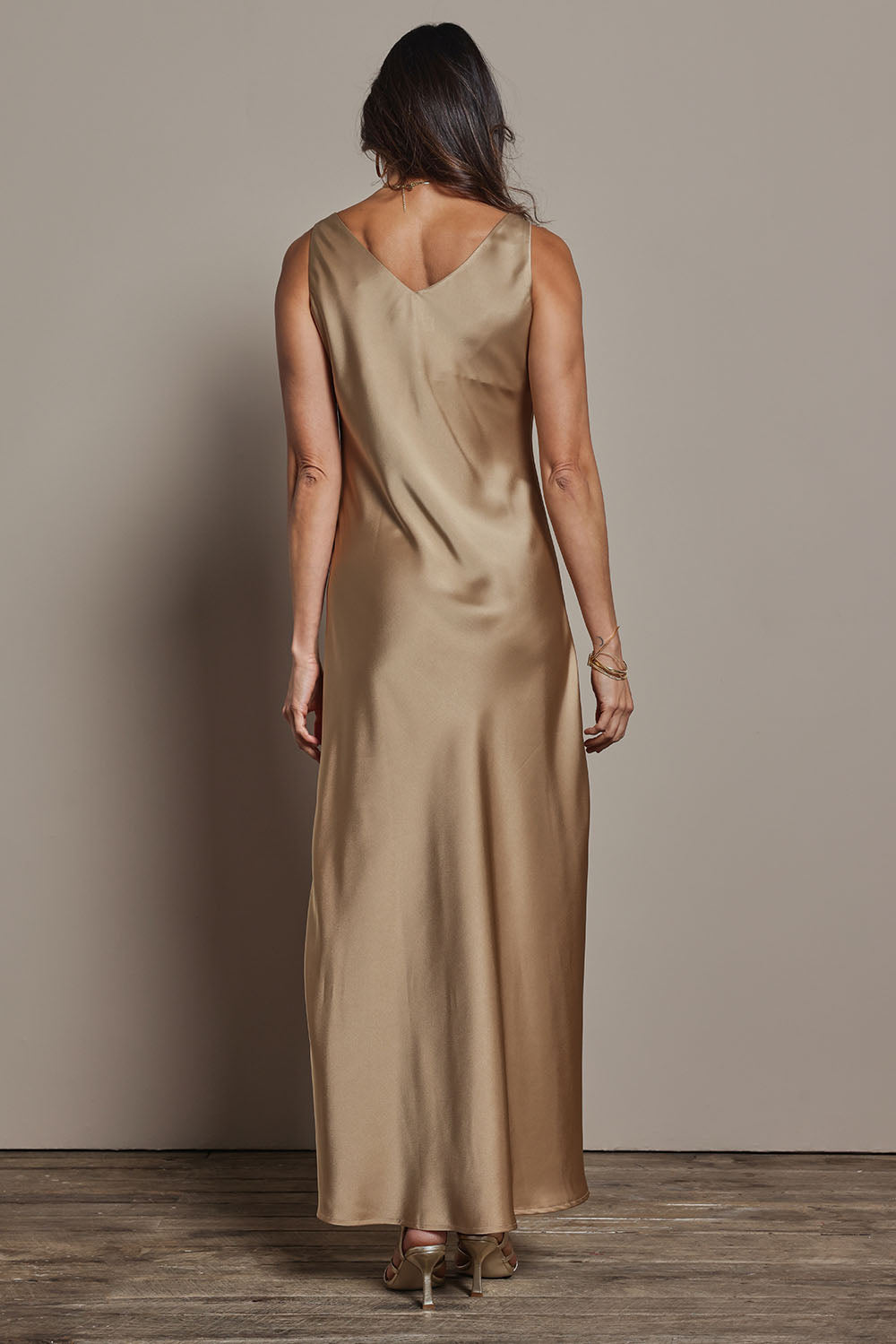 Model Amanda wearing size 10 of the Loulou Satin Slip Dress in colour Latte, from the back