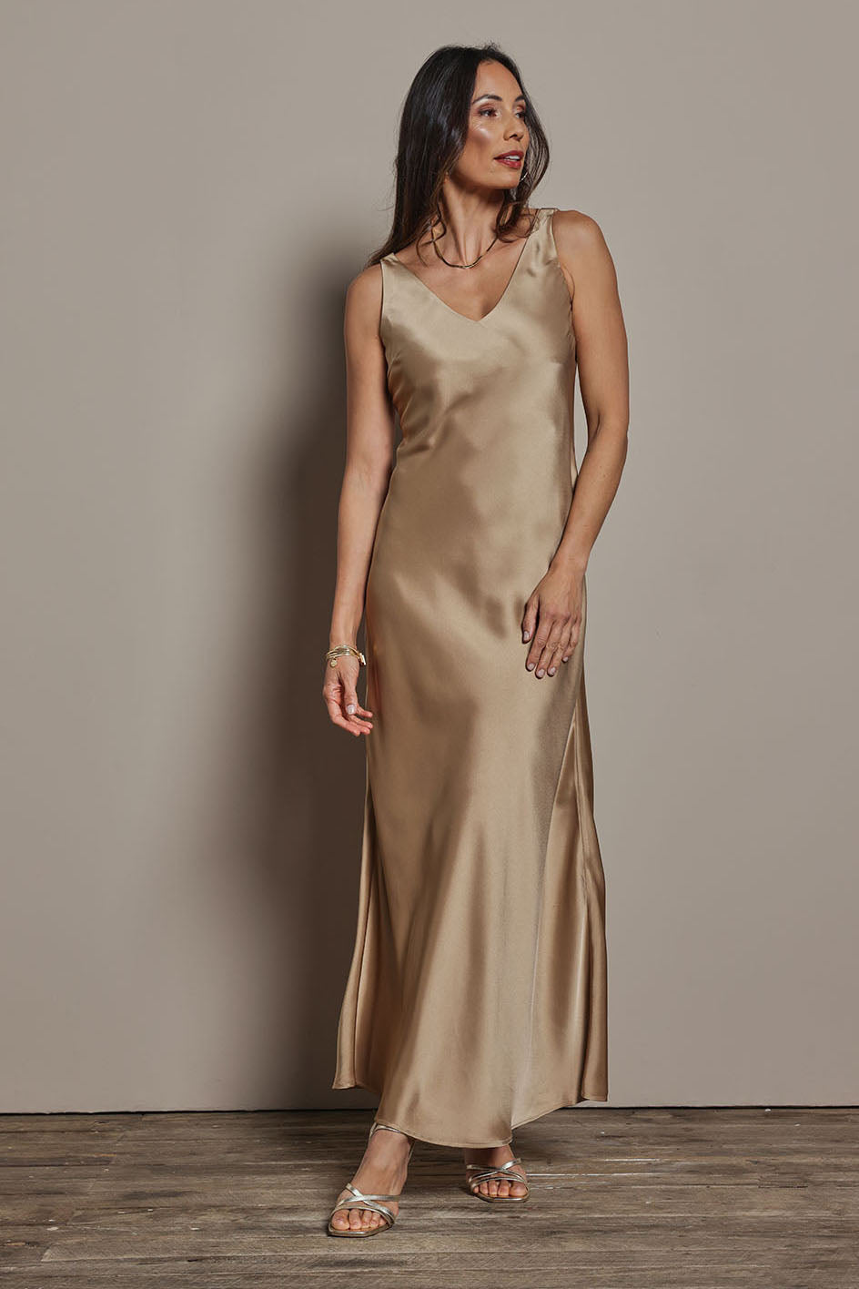 Model Amanda wearing size 10 of the Loulou Satin Slip Dress in colour Latte, from the front, showing the whole outfit