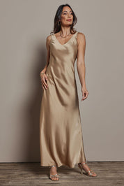 Model Amanda wearing size 10 of the Loulou Satin Slip Dress in colour Latte, from the front, showing the whole outfit