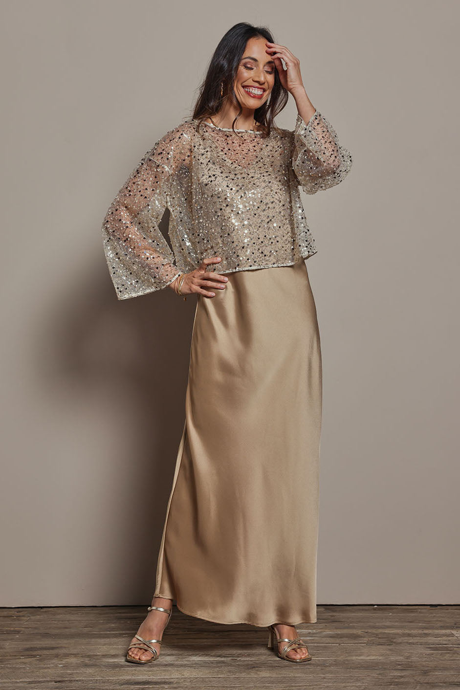 Model Amanda wearing size 10 of the Loulou Satin Slip Dress in colour Latte, from the front, showing the whole outfit