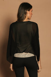 Model Madeline wearing size 10 of the Ria Top in colour Blackgold (Black), from the back