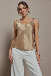 Model Madeline wearing size 10 of the Celeste Satin Camisole in colour Latte, from the front, cropped image