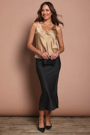 Model Madeline wearing size 10 of the Celeste Satin Camisole in colour Latte, from the front, showing the whole outfit