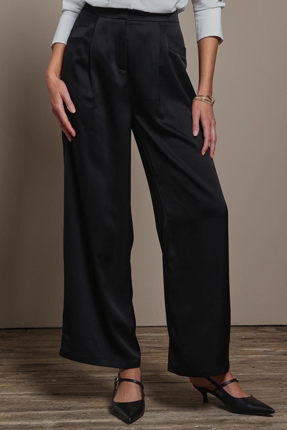 Model Madeline wearing size 10 of the Amelia Pants in colour Black (Black), from the front, cropped image