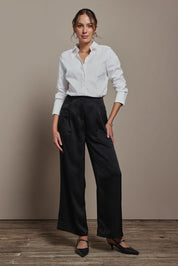 Model Madeline wearing size 10 of the Amelia Pants in colour Black (Black), from the front, showing the whole outfit