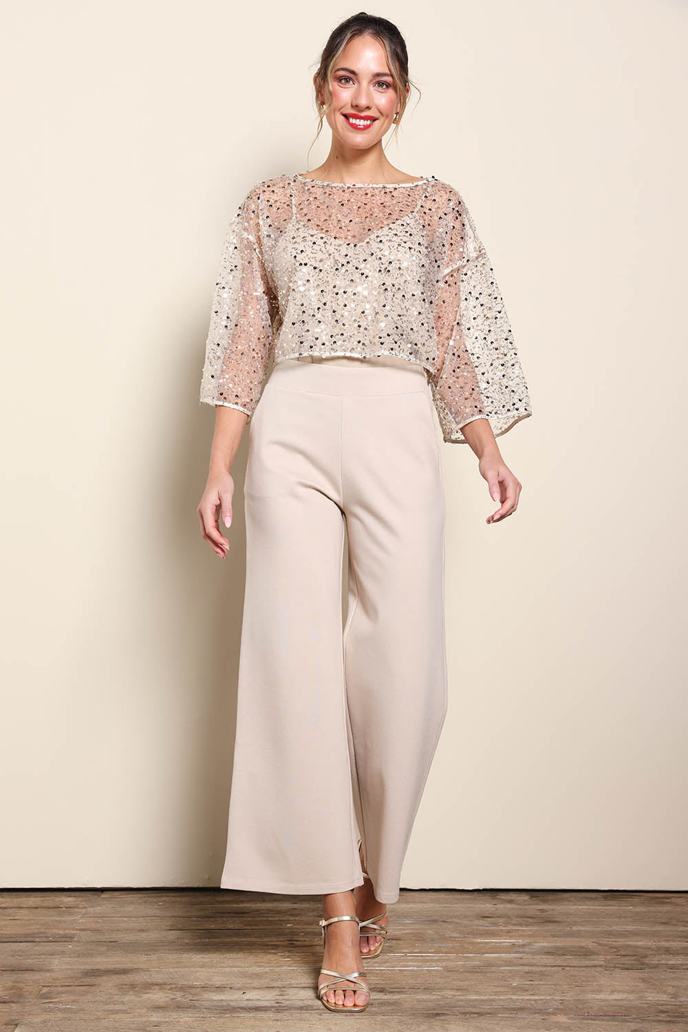 Model Maddiec wearing size 10 of the Petite Nina Sequin Top – Gold in colour Gold, from the front