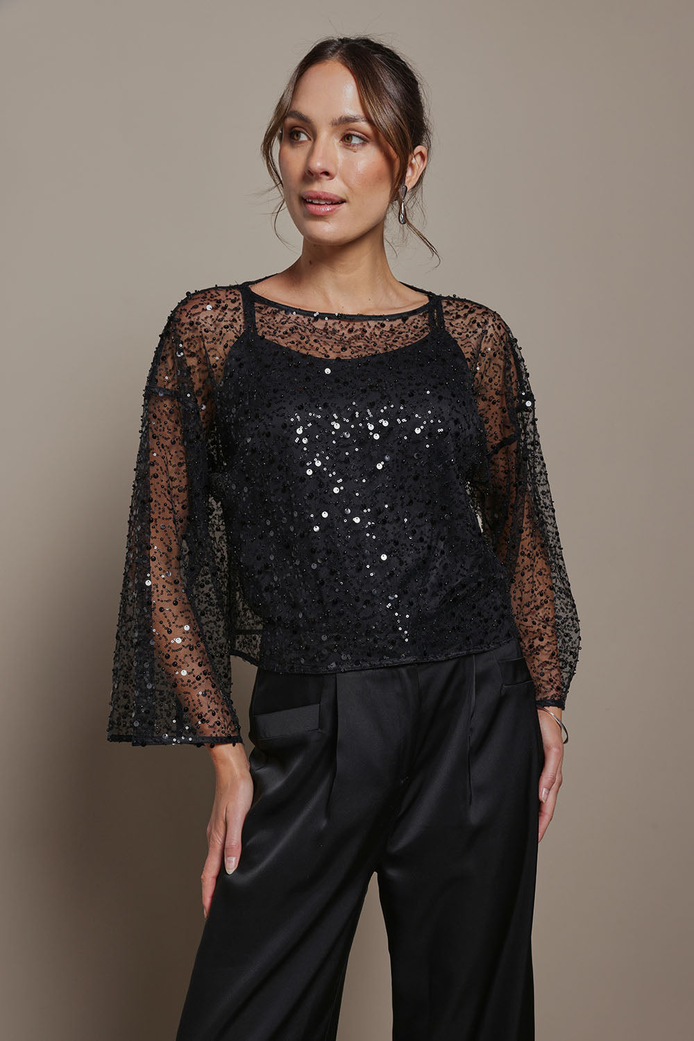 Model Madeline wearing size S of the Nina Sequin Top in colour Black (Black), from the front, cropped image