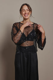 Model Madeline wearing size S of the Nina Sequin Top in colour Black (Black), from the front, cropped image