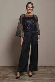 Model Madeline wearing size S of the Nina Sequin Top in colour Black (Black), from the front, showing the whole outfit