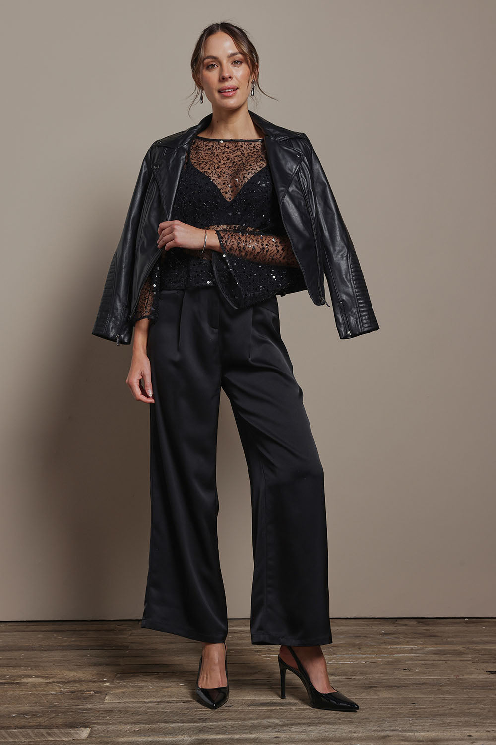 Model Madeline wearing size S of the Nina Sequin Top in colour Black (Black), from the front, showing the whole outfit
