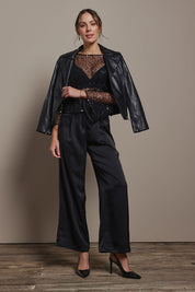 Model Madeline wearing size S of the Nina Sequin Top in colour Black (Black), from the front, showing the whole outfit