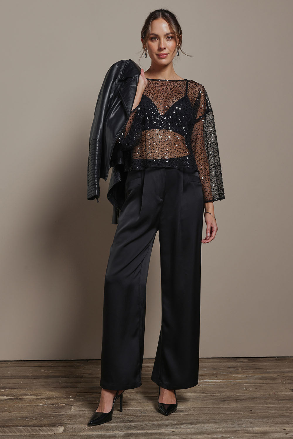 Model Madeline wearing size S of the Nina Sequin Top in colour Black (Black), from the front, showing the whole outfit