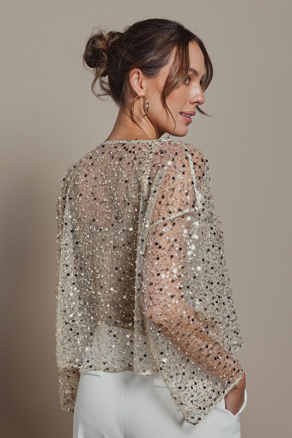 Model Madeline wearing size S of the Nina Sequin Top in colour Gold (Metallics), from the back