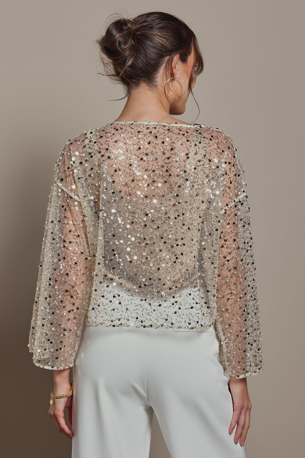 Model Madeline wearing size S of the Nina Sequin Top in colour Gold (Metallics), from the back