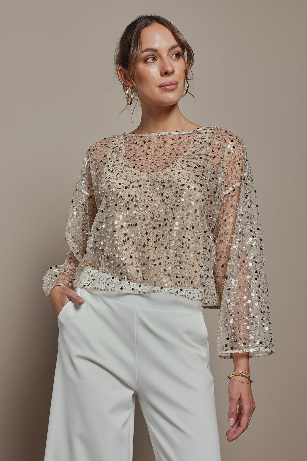 Model Madeline wearing size S of the Nina Sequin Top in colour Gold (Metallics), from the front, cropped image