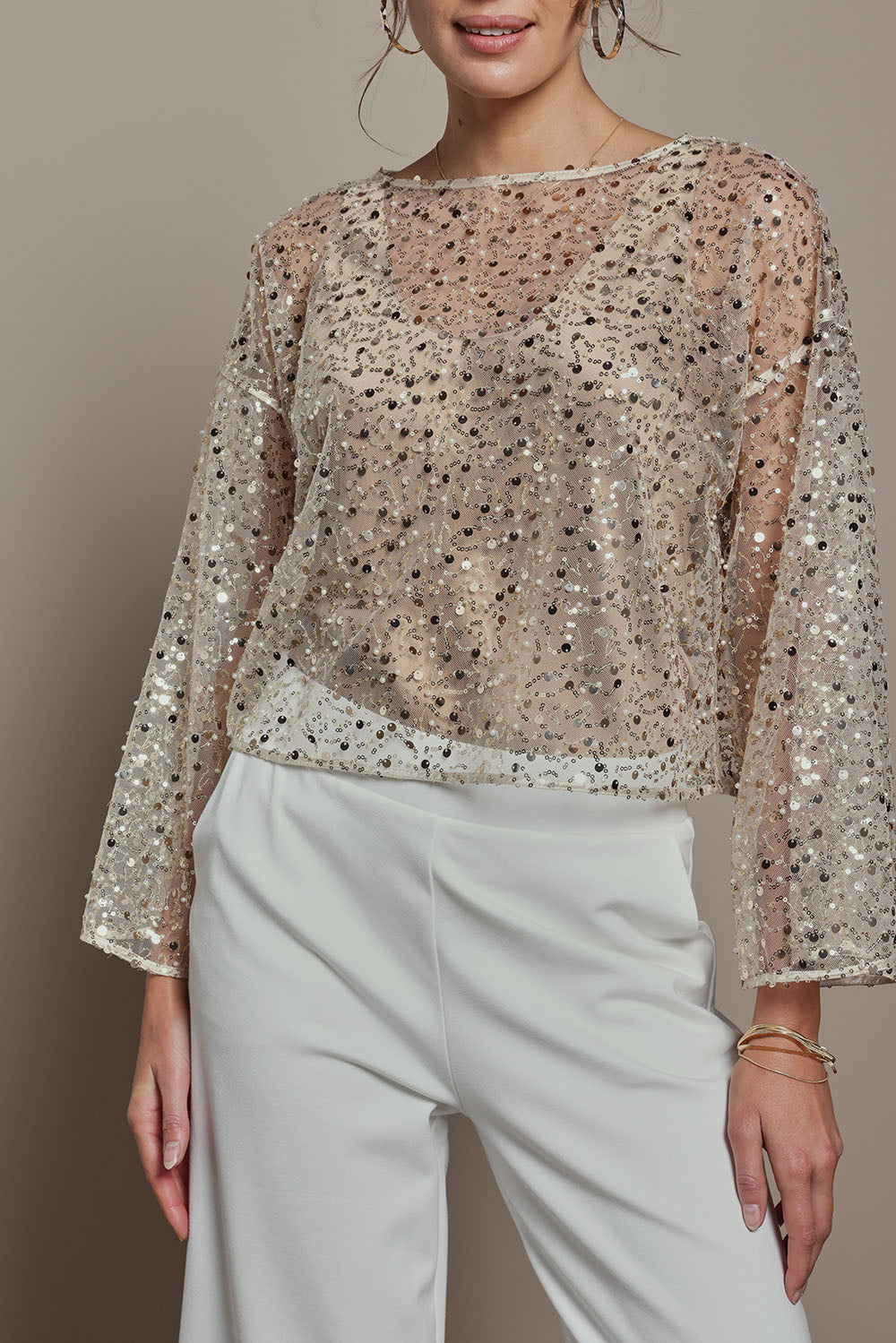 Model Madeline wearing size S of the Nina Sequin Top in colour Gold (Metallics), from the front, cropped image