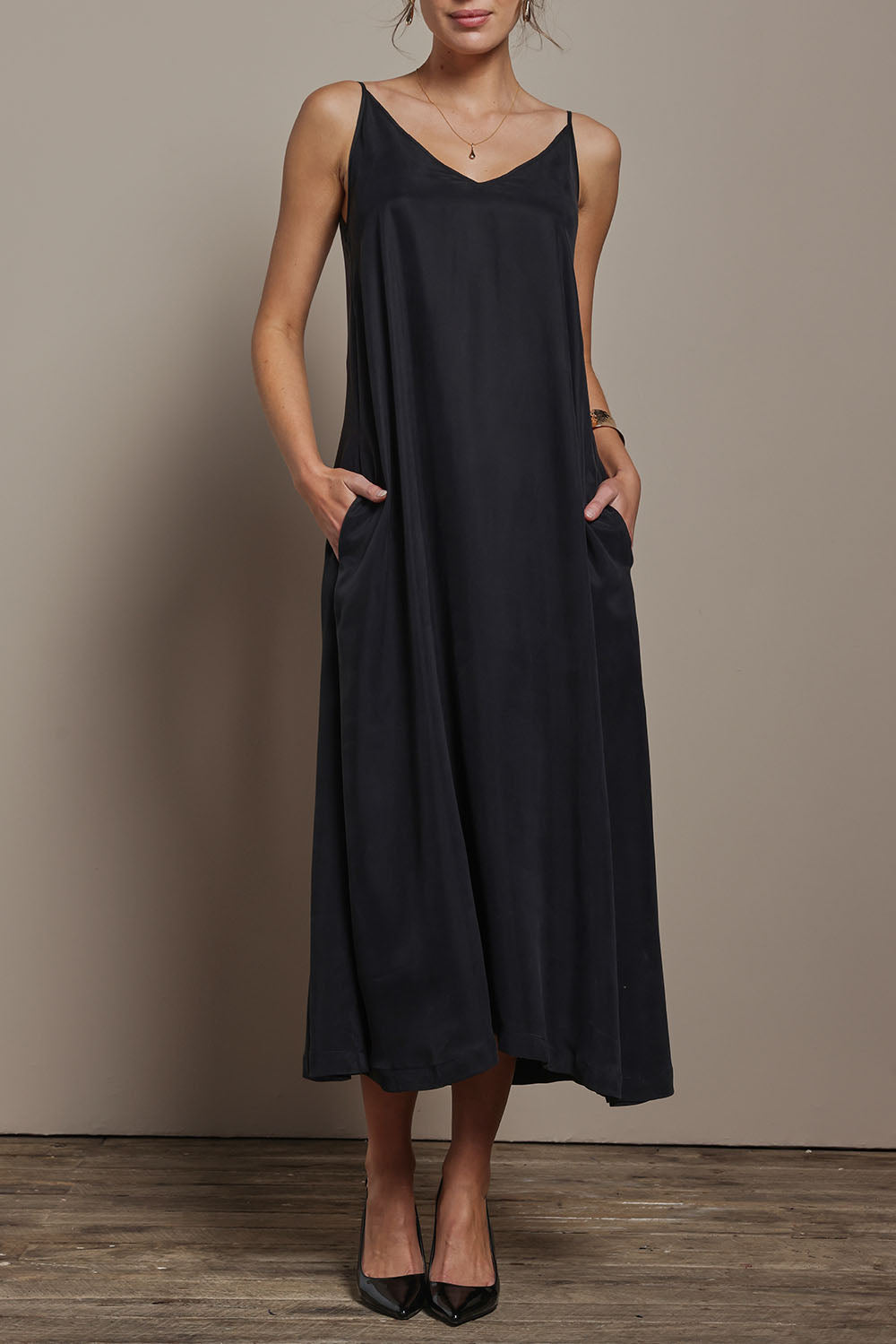 Model Madeline wearing size 10 of the Edith Dress in colour Black (Black), from the front, cropped image
