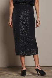 Model Amanda wearing size 10 of the Reegan Sequin Skirt in colour Black (Metallics), from the back