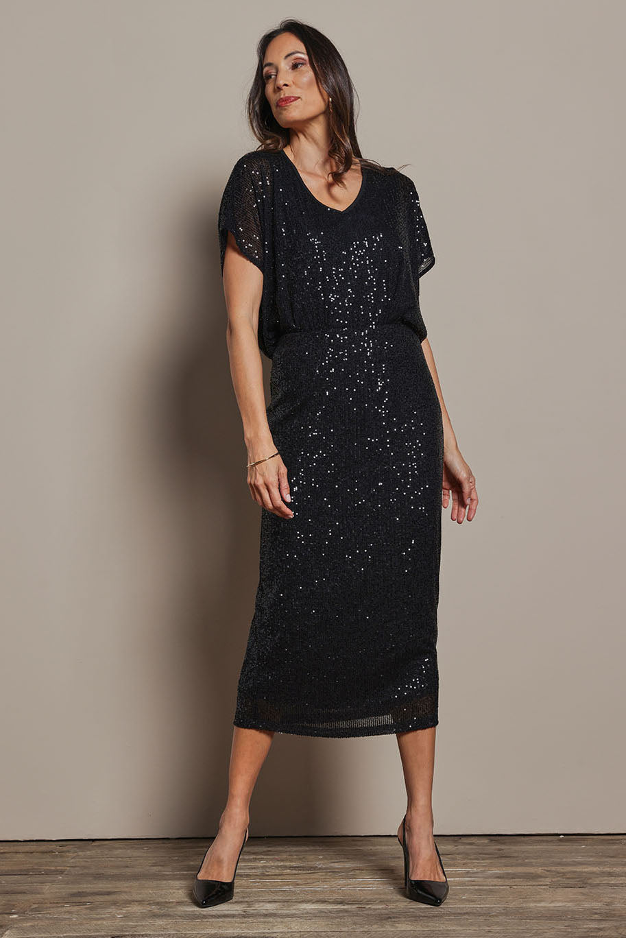 Model Amanda wearing size 10 of the Reegan Sequin Skirt in colour Black (Metallics), from the front, showing the whole outfit