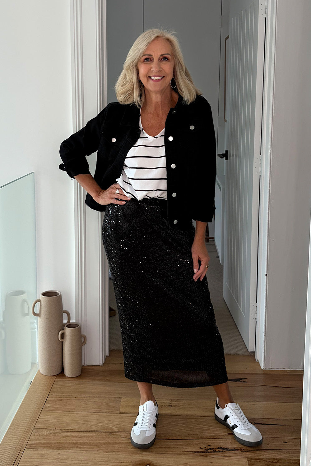Model Sandy wearing size 10 of the Reegan Sequin Skirt in colour Black (Metallics), from the front, showing the whole outfit