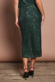 Model Madeline wearing size 10 of the Reegan Sequin Skirt in colour Forest (Metallics), from the back