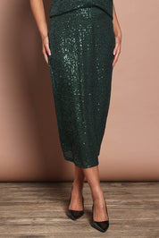 Model Madeline wearing size 10 of the Reegan Sequin Skirt in colour Forest (Metallics), from the front, cropped image