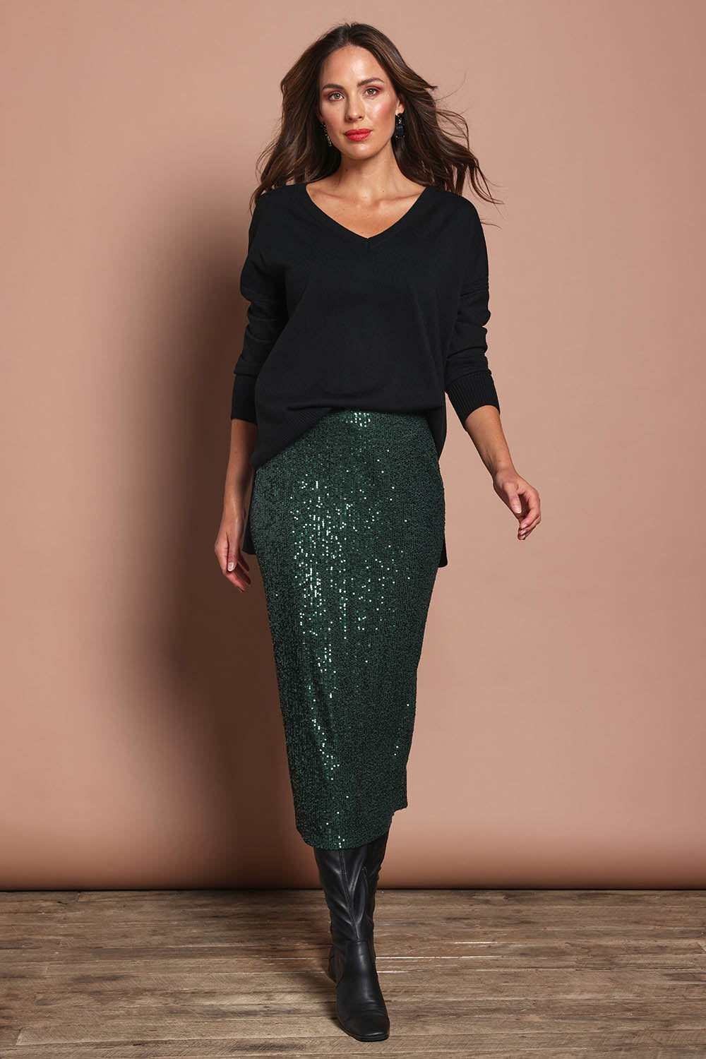 Model Madeline wearing size 10 of the Reegan Sequin Skirt in colour Forest (Metallics), from the front, showing the whole outfit