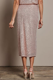 Model Amanda wearing size 10 of the Reegan Sequin Skirt in colour Rosegold (Metallics), from the back
