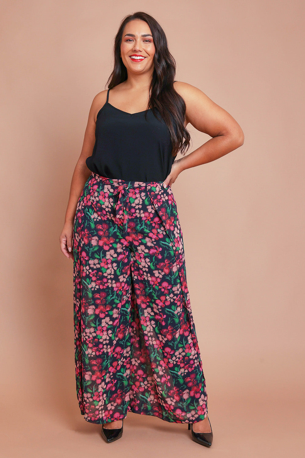 Model Ashleigh wearing size 16 of the Annette Pants in colour Blossom (Black), from the front, showing the whole outfit