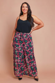 Model Ashleigh wearing size 16 of the Annette Pants in colour Blossom (Black), from the front, showing the whole outfit