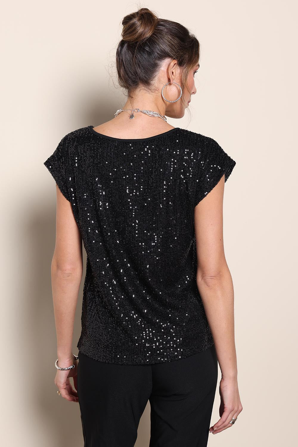 Model Maddiec wearing size 10 of the Reegan Sequin Top – Black in colour Black, from the back