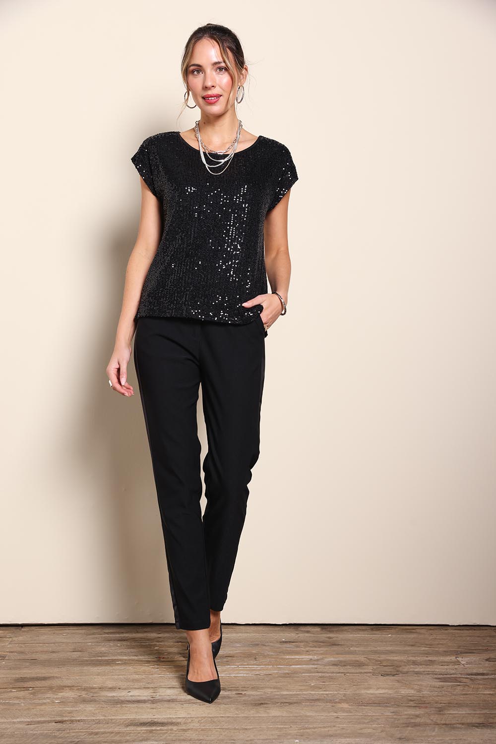 Model Maddiec wearing size 10 of the Reegan Sequin Top – Black in colour Black, from the front