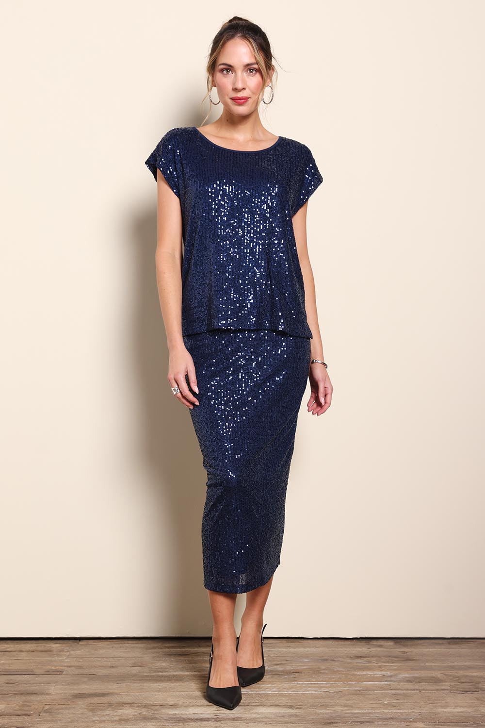 Model Maddiec wearing size 10 of the Reegan Sequin Top – Navy in colour Navy, from the front