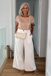 Model Sandy wearing size 10 of the Reegan Sequin Top in colour Rosegold (Metallics), from the front, showing the whole outfit
