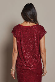 Model Amanda wearing size 10 of the Reegan Sequin Top in colour Rouge (Metallics), from the back