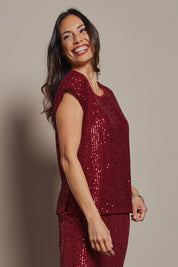 Model Amanda wearing size 10 of the Reegan Sequin Top in colour Rouge (Metallics), from the front, cropped image