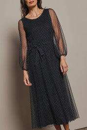 Model Amanda wearing size 10 of the Lorraine Dress in colour Whitedot (Black), from the front, showing the whole outfit