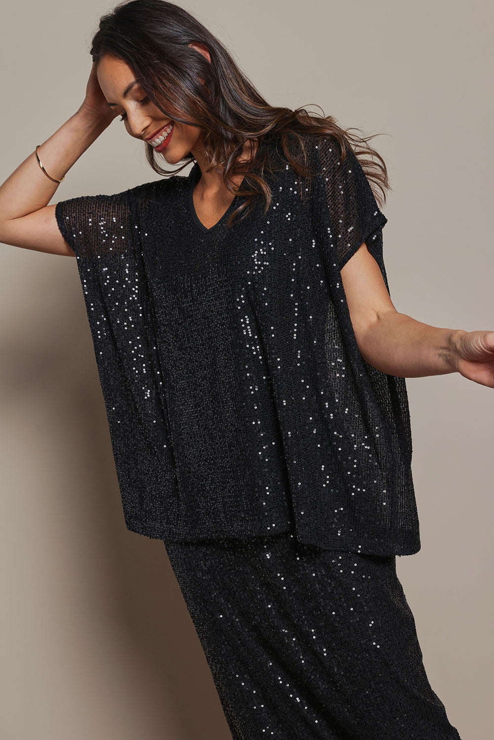 Model Amanda wearing size 10 of the Renee Sequin Top in colour Black (Metallics), from the front, cropped image
